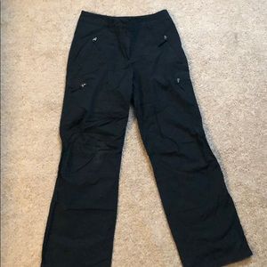 Black cargo style pants with zip pockets.